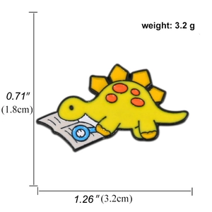 Cartoon yellow stegosaurus enamel pin with dimensions 3.2x1.8cm and 3.2g weight
