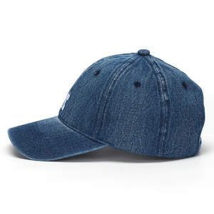 Detailed side view of navy blue washed denim baseball cap with white NYC embroidery