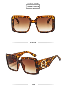 Detail view of leopard print square sunglasses with gold accents and brown gradient lenses