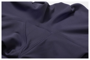 Macro detail of high-density flatlock stitching and gusset on purple yoga flare pants