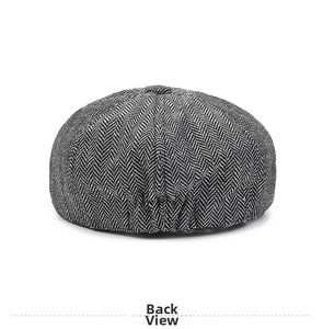 Rear view of herringbone newsboy cap showing grey wool blend fabric and button detail