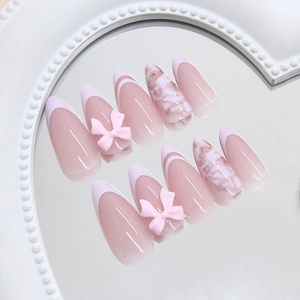 French style almond press-on nails with pink gradient, bow charms, and glitter marble finish