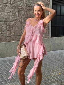 Detail of pink ruffled V-neck top with layered frills and delicate spaghetti straps