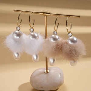 Elegant C-shaped drop earrings with faux pearls and plush fur balls in white and khaki