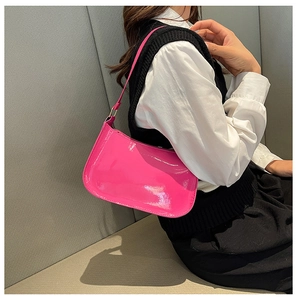 Glossy magenta patent leather underarm bag for women with polished metal buckle detail