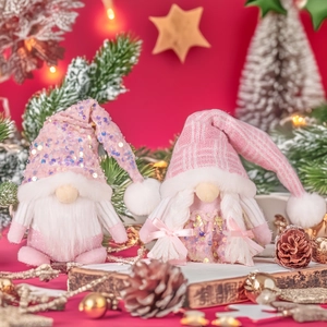 Detail of pink Christmas gnomes set with sequined hats and white braided hair
