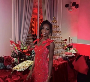 Detailed view of intricate red lace hollow pattern on a luxury evening party dress