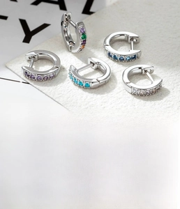 Detail view of mini 6mm and 8mm silver copper hoops with multi-color zircon stones