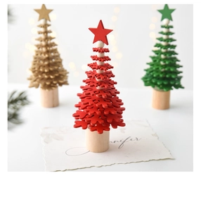Close-up of mini wooden snowflake Christmas tree desk decor with warm festive lights
