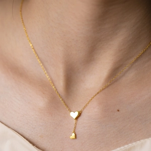 Elegant 925 silver gold-plated Y-necklace featuring double heart pendants on a female model