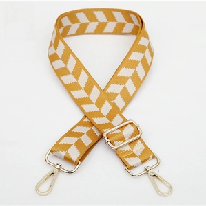 Adjustable jacquard woven bag strap with white chevron pattern and gold metal buckles
