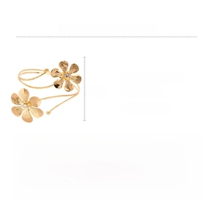 Detail view of golden flower arm cuff featuring dimensions and sparkling diamond accents