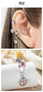 Detailed macro view of heart zircon cat paw pendant paperclip earring on model ear