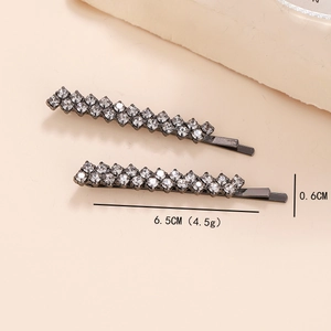 Detailed view of gunmetal hair clips with sparkling rhinestones measuring 6.5cm in length