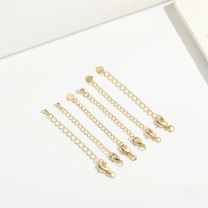 Detailed set of six gold extension chains featuring lobster clasps and heart-shaped charms