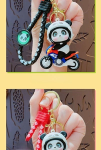 Detail of motorcycle panda keychain with woven leather strap and gold metal clasp