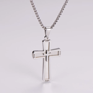 Detailed close-up of a silver stainless steel double-layered cross pendant with chain
