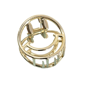 Minimalist golden smiley face metal hair claw clip with glossy finish on white background