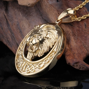 Macro detail of golden lion head pendant with Celtic knot on dark wood background