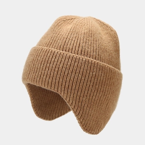 Detailed texture of brown rib-knit beanie showing warm ear flaps and chunky knit pattern