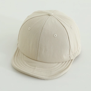 Close-up of beige quick-dry kids baseball cap with soft short brim and six-panel design