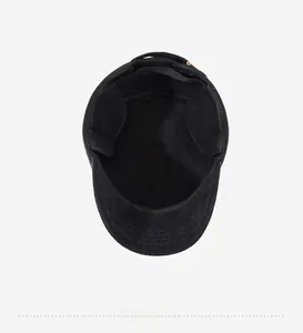 Detailed interior of a black winter flat cap showing ear protection and stitching