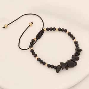 Detail of adjustable black onyx beaded bracelet with gold accents and natural stones