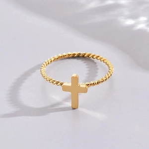 Minimalist gold twisted cable ring featuring a smooth central cross on light background