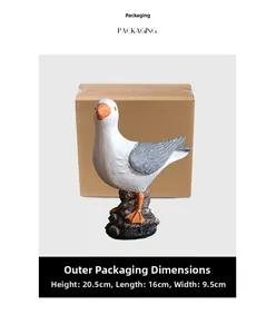 Detailed view of resin seagull ornament with grey wings and protective packaging box
