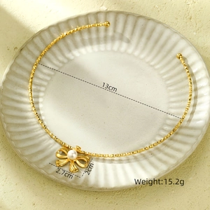 Detailed view of golden bow pearl choker with 13cm diameter and 15.2g weight measurement