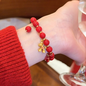 Detailansicht eines eleganten roten Achat-Perlenarmbands mit goldenem Pferdeanhänger