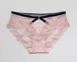 Detail of pink lace panties featuring polka dot mesh and a gold heart-shaped metal buckle