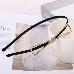 Elegant thin black headband with a golden rhinestone hollow bow knot on a stylish background