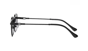 Detail of metal sunglasses featuring unique twisted spiral temples and sleek black frames