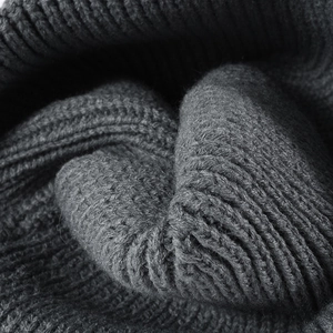Thick dark grey knit winter beanie with ribbed texture and embroidered bow detail