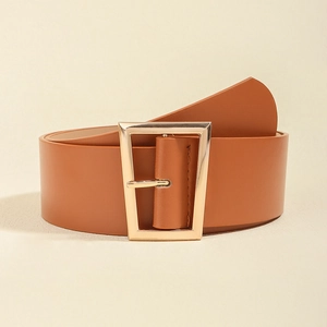 Close-up of brown wide leather waist belt with elegant golden trapezoidal metal buckle