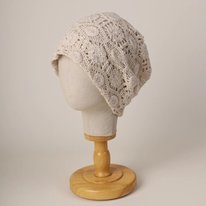 Beige floral lace crochet beanie hat for women featuring a bohemian hollow-out design