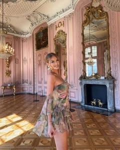 Detail of floral chiffon tube dress with layered ruffles in a luxurious palace setting