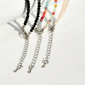 Detail of colorful agate and crystal beaded necklaces with silver lobster clasp and extension chain