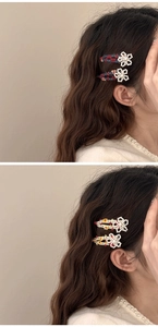 Dettaglio di fermagli per capelli a fiori ricamati con perle sui capelli di una modella