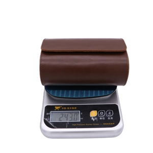 Brown PU leather watch travel case weighing 243g on a digital scale closeup view