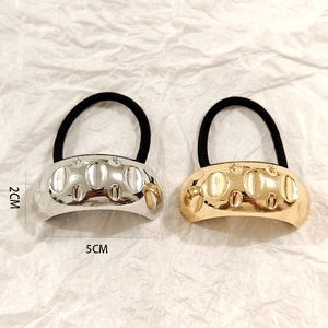 Detailed view of gold and silver hollow metal hair rings with 5cm length dimensions