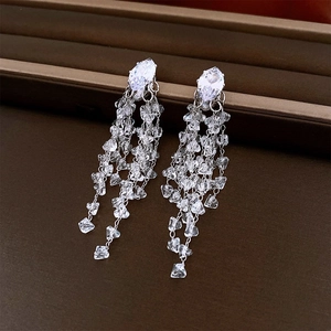 Macro view of long silver tassel earrings featuring marquise-cut crystal rhinestones