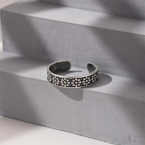 Detail shot of vintage S925 sterling silver open ring with embossed daisy floral pattern