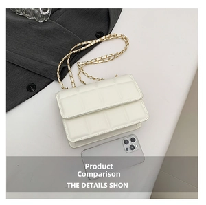 Close-up of white quilted crossbody bag with gold chain strap next to a smartphone