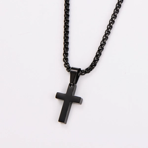 Close-up of a minimalist black stainless steel cross pendant with a matching link chain