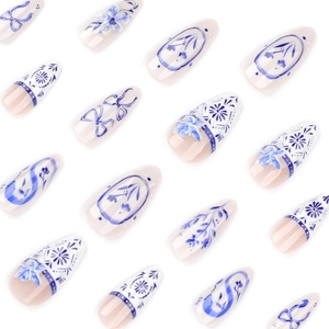 Blue and white porcelain style almond press-on nails with floral and bow patterns