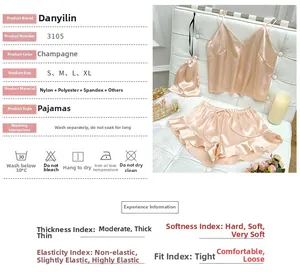 Detailed view of champagne satin pajama set with camisole and ruffled shorts on white seat