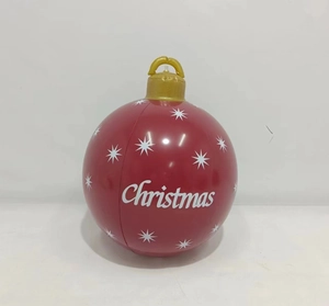 Detail of red Christmas inflatable ball with white stars and golden crown cap on top