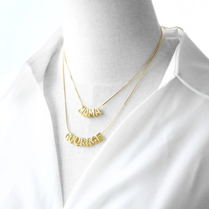 Gold-plated layered snake chain necklaces featuring MAMA and COURAGE letter pendants